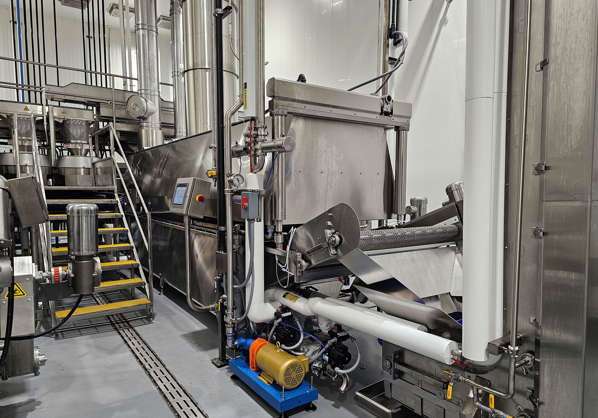 Batch fryer installation with controls, piping, and exhaust system